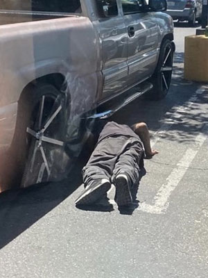 catalytic converter thief under car