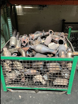 large number of stolen catalytic converters in a metal parts bin