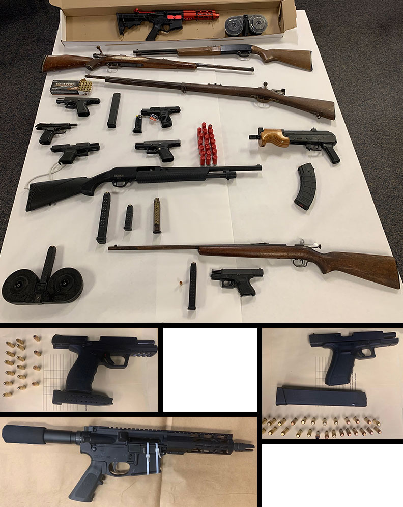 gun collage - table full of guns and ammo collected as evidence